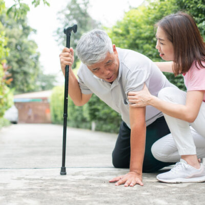Asian senior man falling down at home in the backyard caused by myasthenia (Muscle Weakness) and the nurse came to help support. Concept of old elderly insurance and health care